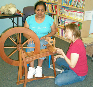 Photo of a guild member teaching spinning